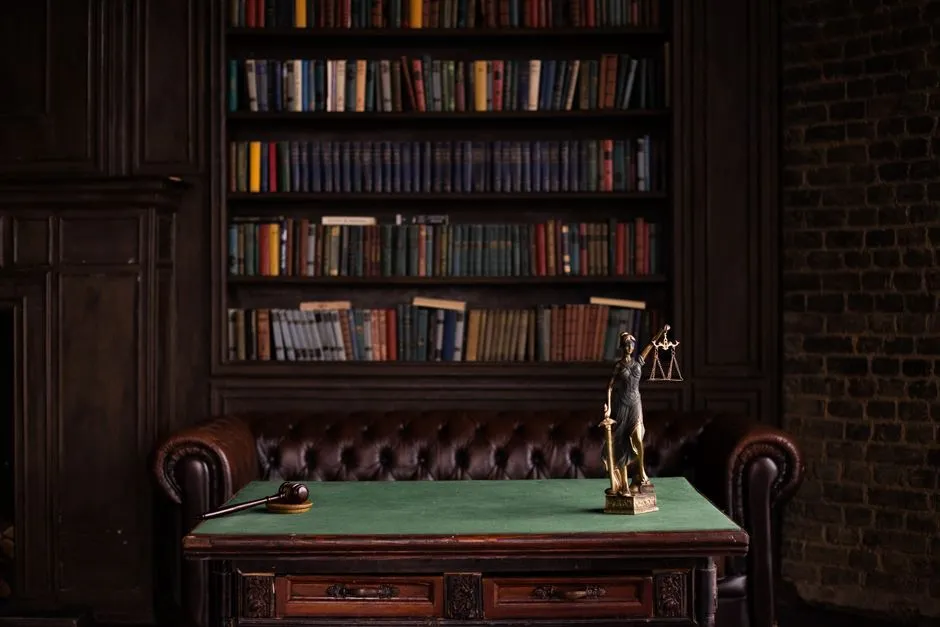 Scales of justice figurine on a desk, representing legal research and the personal injury claim process